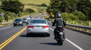 Motorcycle following sedan on road